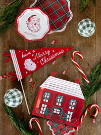 Red house-shaped plates styled with a Santa pennant and candy canes