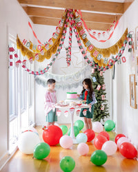 Striped square Christmas plates styled at a holiday party backdrop