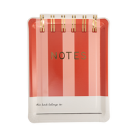 Red and pink striped notebook shaped paper plate with gold foil spiral binding, gold foil "NOTES" title, and "this book belongs to" writing line at bottom
