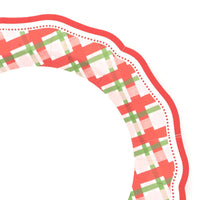 Angled close-up of the plaid dinner plate showing the red scalloped rim and tartan pattern.