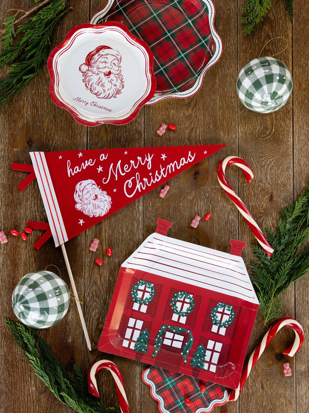 Red Santa felt pennant styled with holiday decor and candy canes