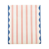 Flat lay of red striped paper table runner showing pinstripe pattern and blue wave scallop border on each edge