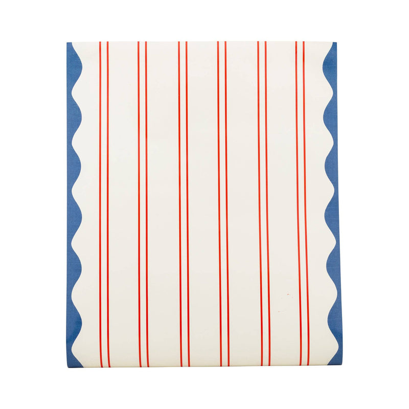 Flat lay of red striped paper table runner showing pinstripe pattern and blue wave scallop border on each edge