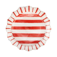 Front of red and cream striped scalloped paper dinner plate in cellophane packaging showing hand-painted stripe pattern