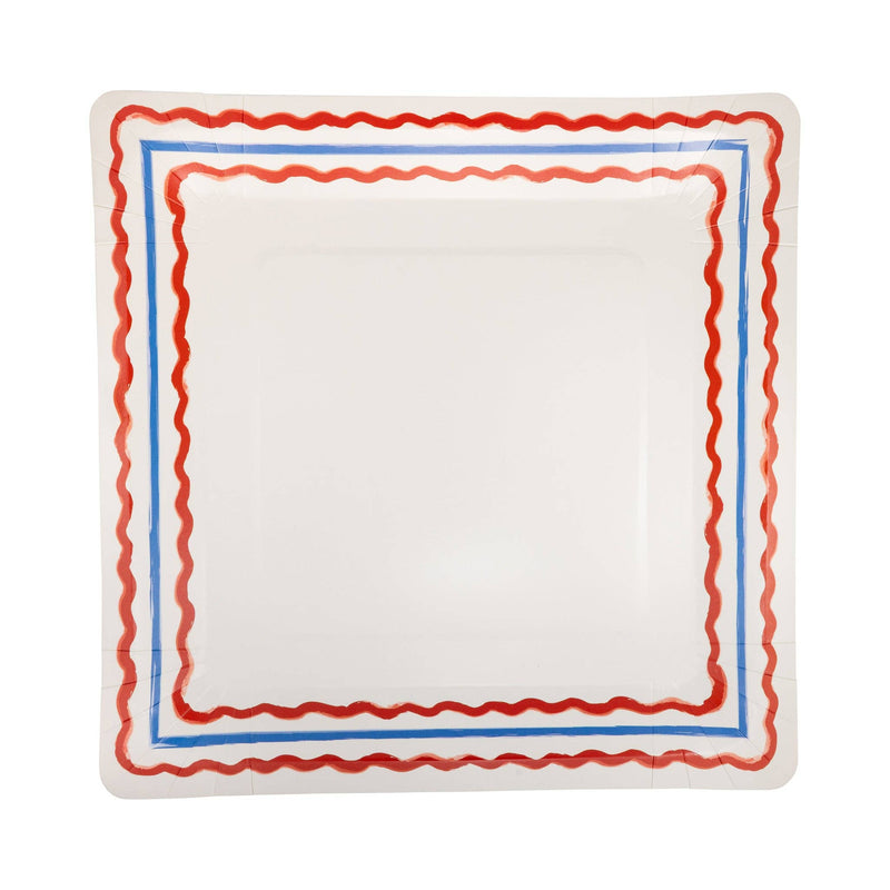 Top-down view of a cream square 11 inch paper dinner plate with a double red wavy rickrack border and thin blue pinstripe detail on a white background