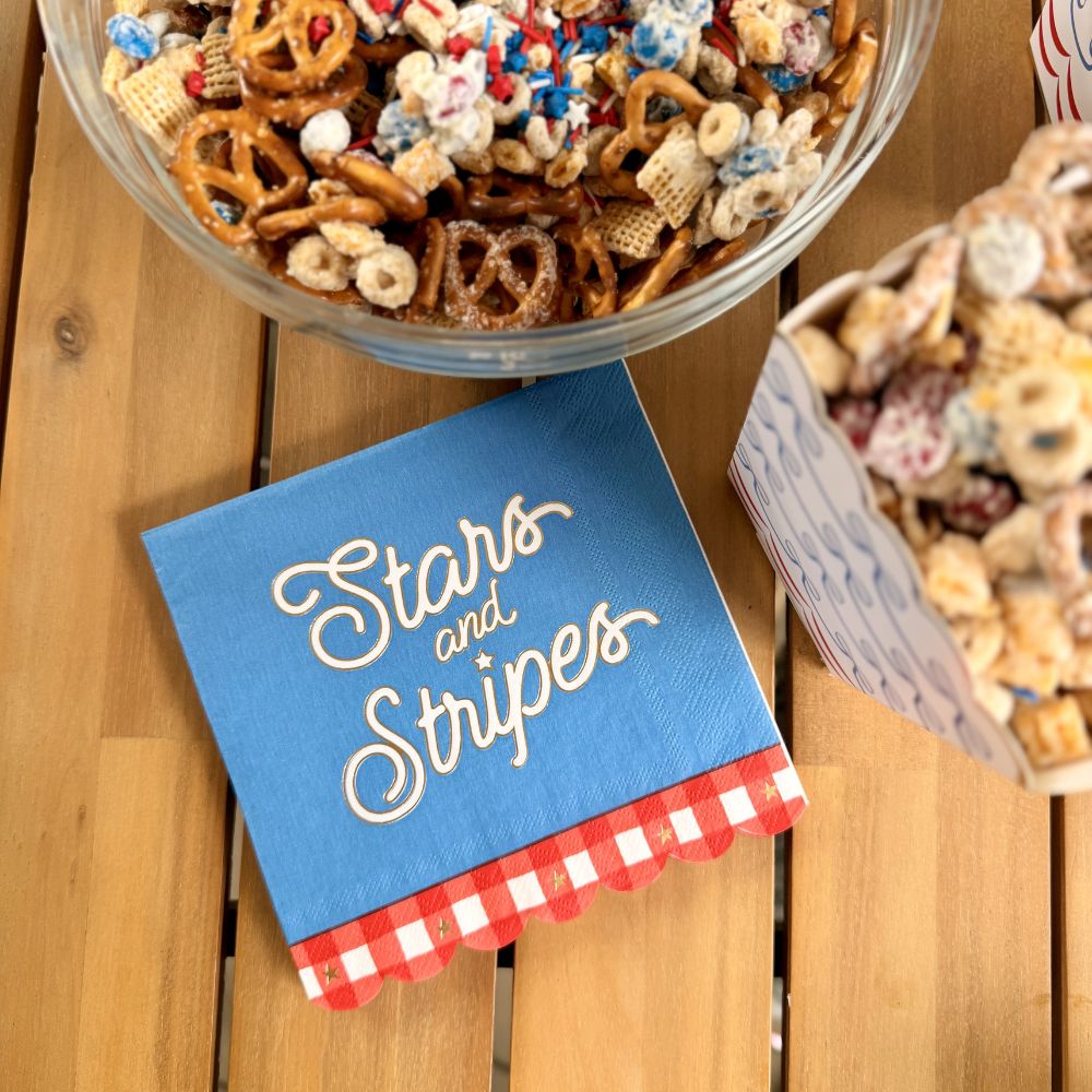 patriotic table setting with stars and stripes napkins and matching 4th of July decorations