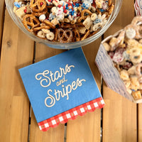 patriotic table setting with stars and stripes napkins and matching 4th of July decorations