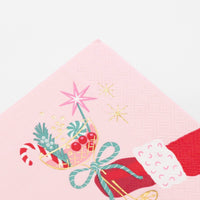 Close-up macro detail of the top half of the pink napkin illustration, focusing on the candy cane, holly, and foil stars inside the coupe glass.