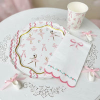 Ballerina plate and bow napkin styled on a white vintage table