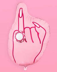 Front view of inflated pink ring finger diamond balloon on pink background showing full hand shape, hot pink line art, and 3D diamond ring