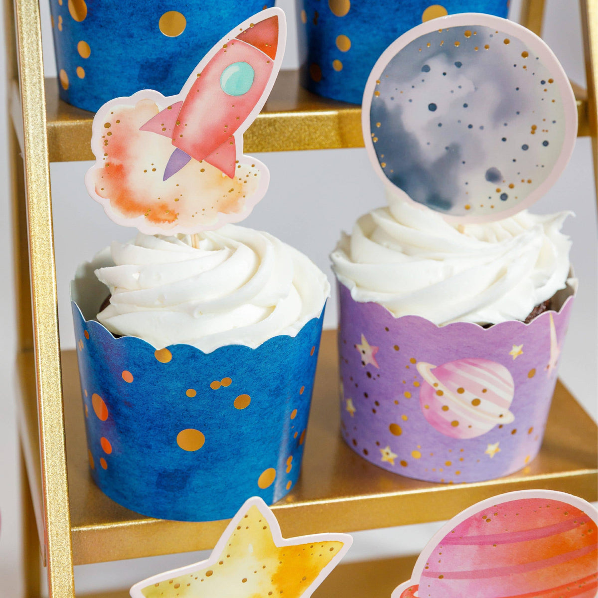 rocket and moon cupcake toppers on space themed cupcakes