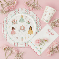 Princess cup and plate setting on a pink wooden background with roses
