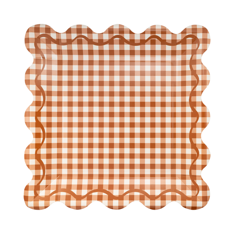 Rust gingham square paper plate in orange and cream checks with a scalloped edge, front view.