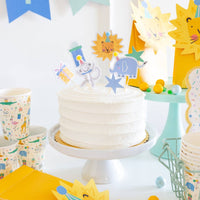 Safari cupcake picks decorating a birthday cake with Kids birthday party supplies.