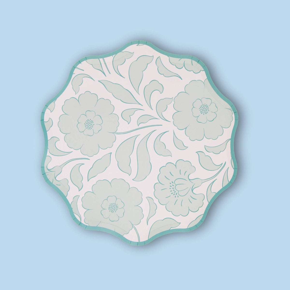 Single sage-green block-print floral scalloped paper plate on a light blue background.