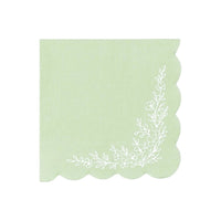 sage green cocktail napkin with scalloped edge and floral corner design.