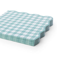 Sage green gingham napkins shown folded and stacked at an angle