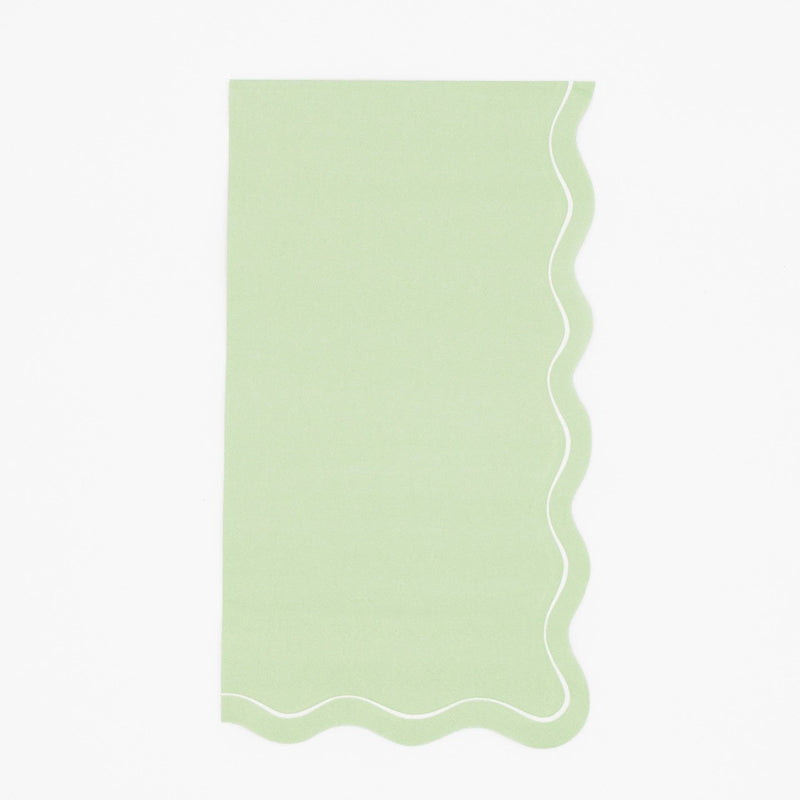 Solid sage green guest towel with a flowing scalloped white-outlined edge, flat view on white background.