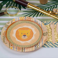 sage green striped table runner with safari themed place setting and lion plate.