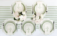 An ethereal easter table setting featuring four place settings with botanical cross napkins and sage lattice plates in a secret garden style.