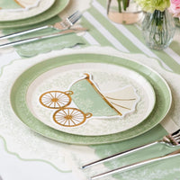 sage placemat layered under baby shower dinner plates and napkin.