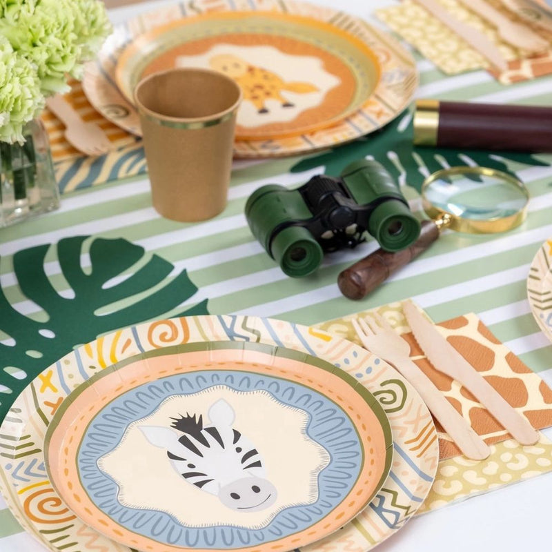 sage striped table runner with safari themed table setting and zebra plate.