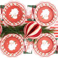 Overhead with Santa plates, striped ornaments, wreath plates, and evergreen.