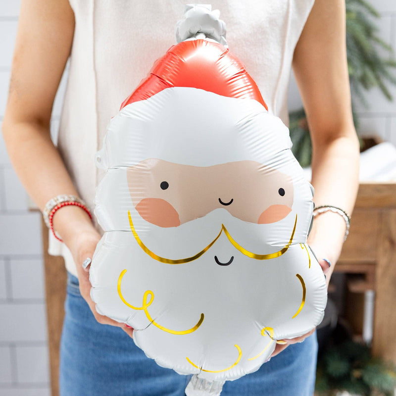 Close-up of person holding inflated Santa Mylar Balloon