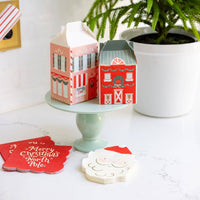 Santa napkin styled with North Pole treat boxes and Merry Christmas napkins