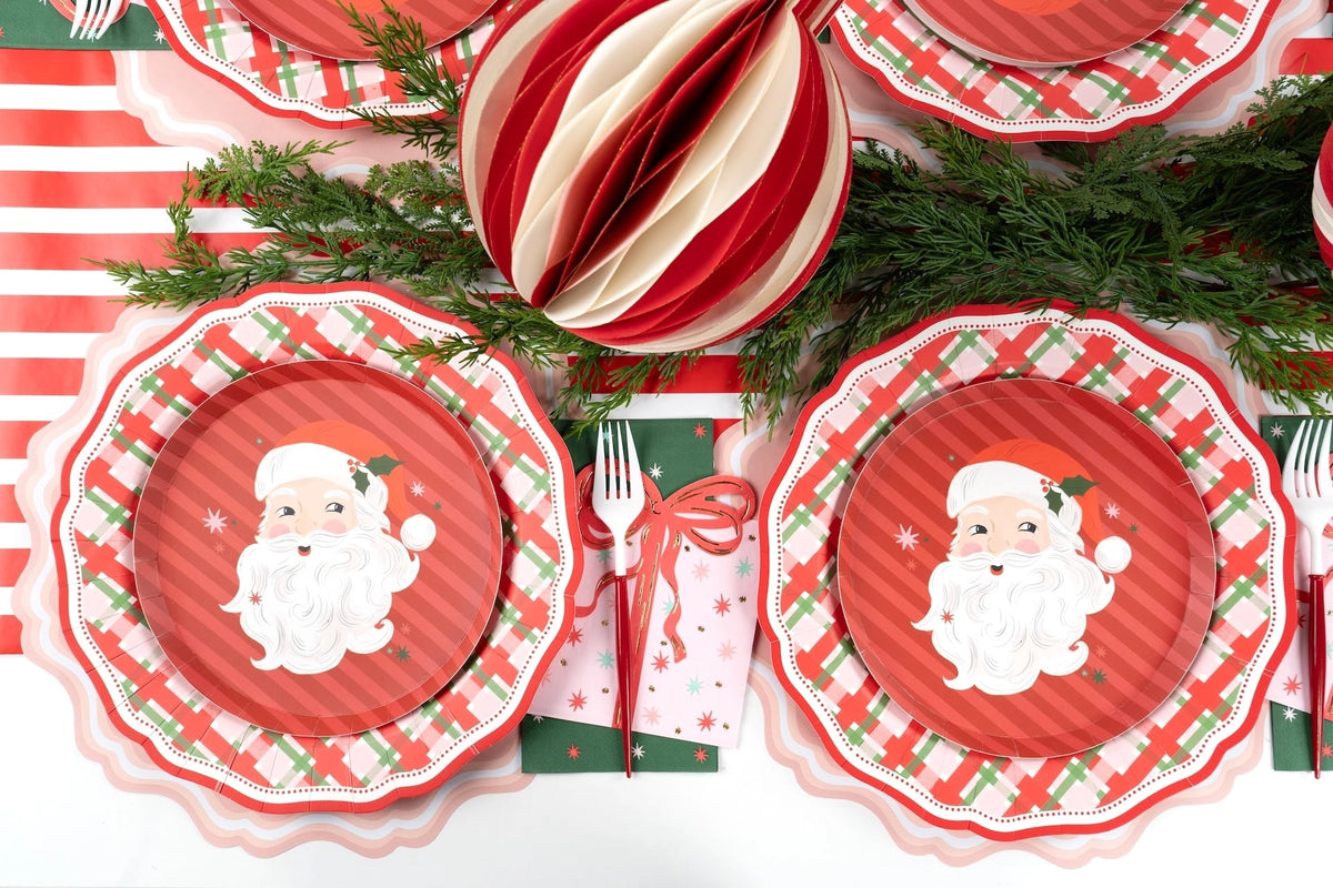 Overhead with striped ornaments, Santa plates on red gingham plates, and green star guest towels.