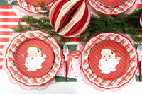Overhead with striped ornaments, Santa plates on red gingham plates, and green star guest towels.