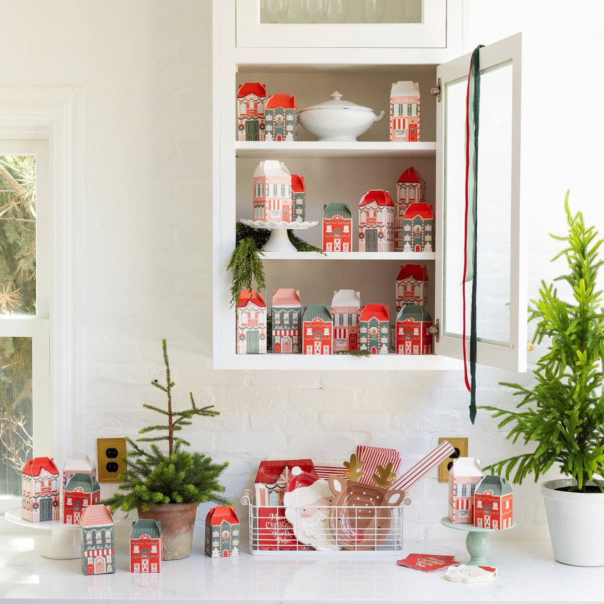 Santa plate styled on holiday counter with other Christmas tableware