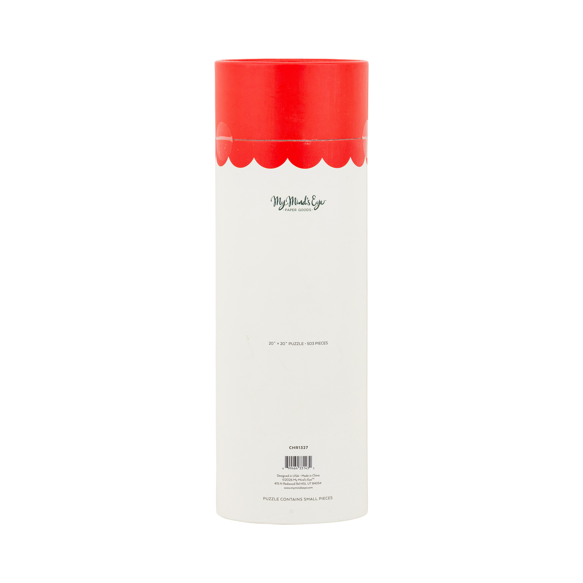 Santa's Bakery puzzle tube styled with other holiday puzzles among greenery and gift boxes