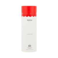Santa's Bakery puzzle tube styled with other holiday puzzles among greenery and gift boxes