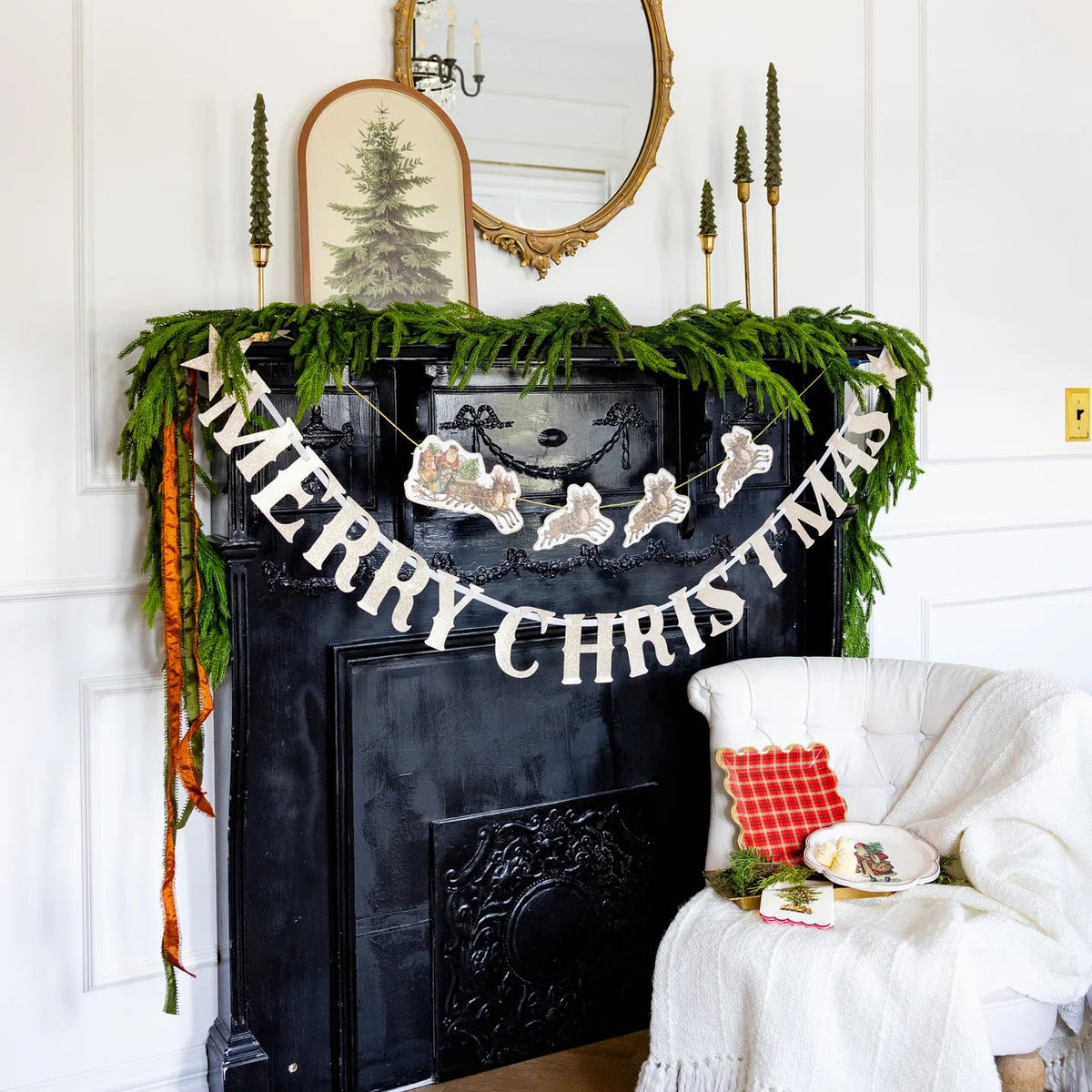 Mantel with greenery and vintage Christmas banner of Santa and reindeer.