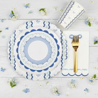 Blue coquette dessert plate layered over a large bow dinner plate with gold fork