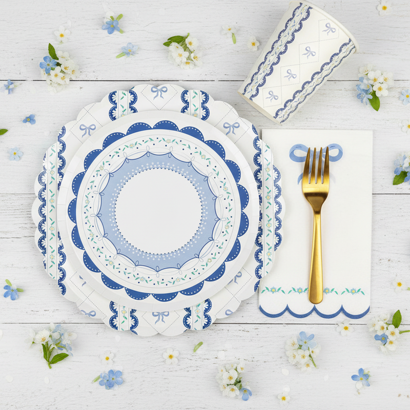 Blue coquette dessert plate layered over a large bow dinner plate with gold fork