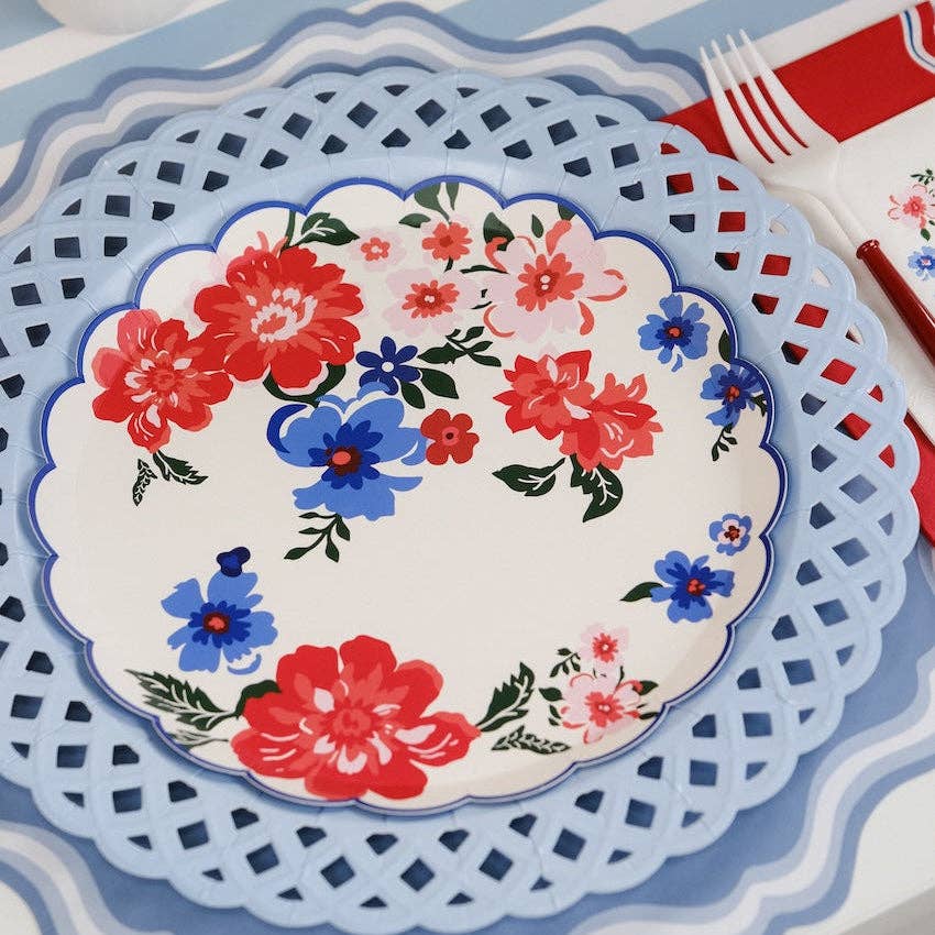 Close-up of an 8-inch Summer Floral Paper Plate on a red lattice-style charger.