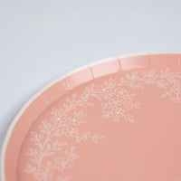 Close-up of scalloped edge on pink dinner plate