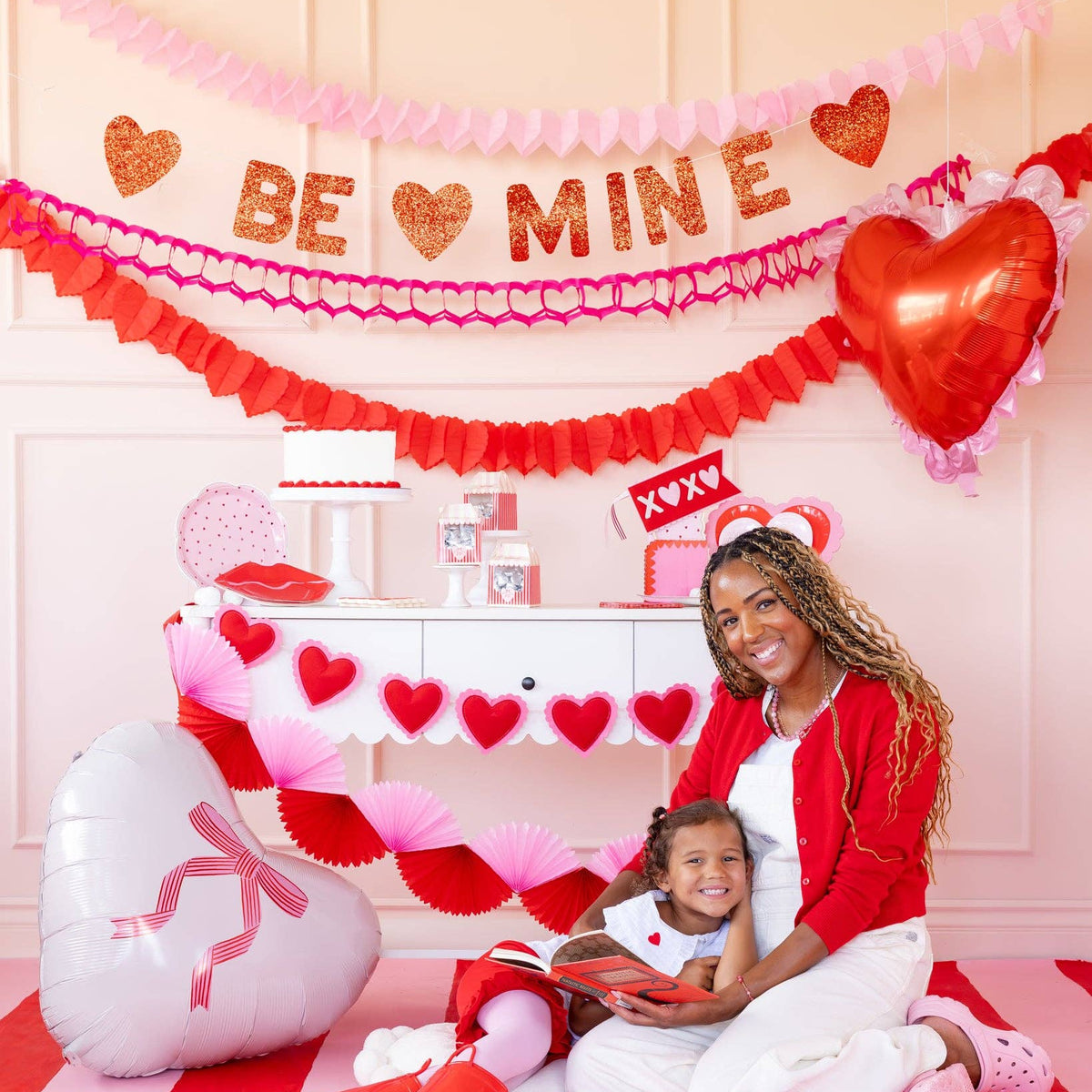 Scalloped heart mylar balloon used as a backdrop accent at a Valentine table