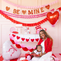 Scalloped heart mylar balloon used as a backdrop accent at a Valentine table