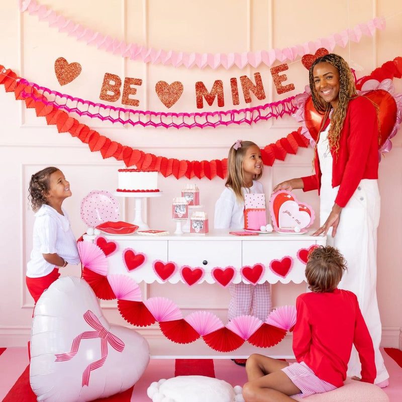 Valentine’s Day table setup featuring scalloped heart border napkins