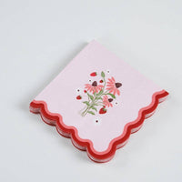 A stack of Strawberry Cocktail Napkins showing the die-cut wavy edge for a Boutique Aesthetic.