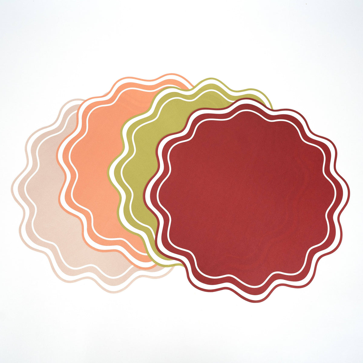 set of wavy scalloped placemats in neutral and seasonal colors
