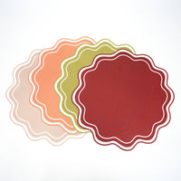 set of wavy scalloped placemats in neutral and seasonal colors
