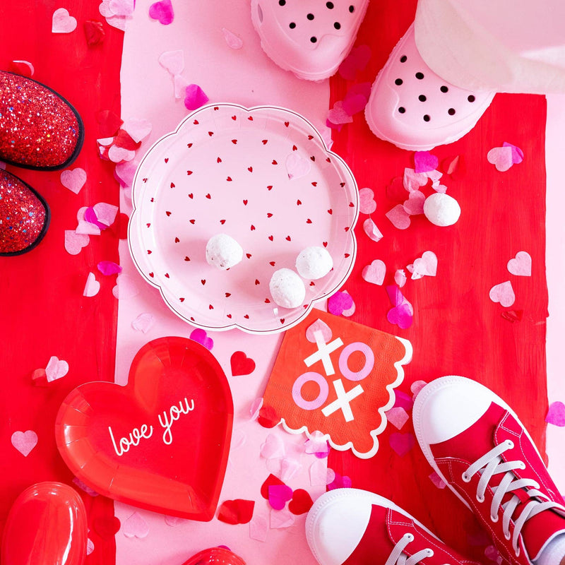 Valentine’s Day setting featuring scalloped XOXO napkins and heart decor