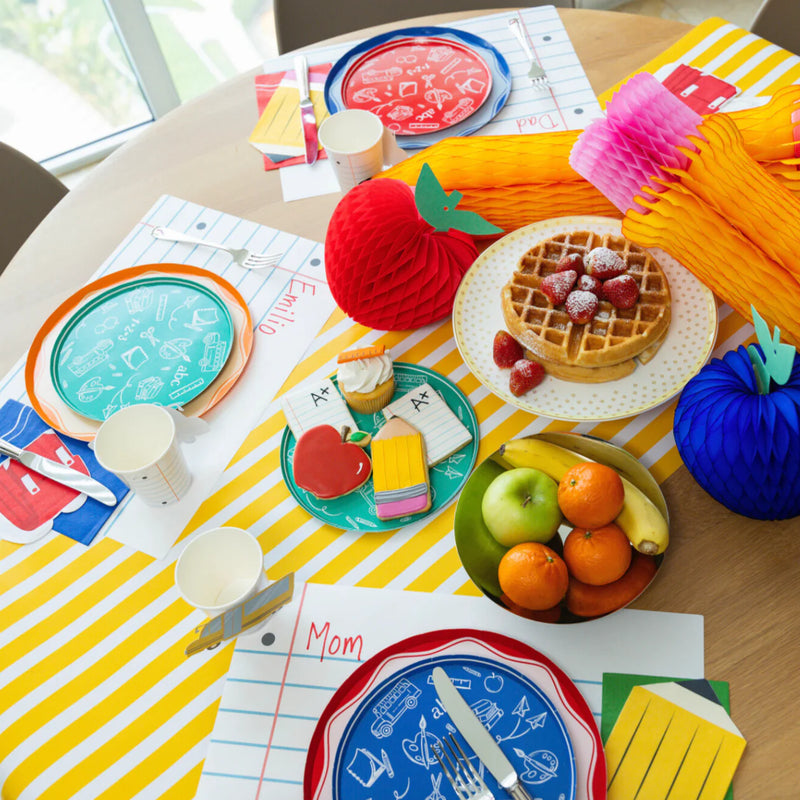 Back to school Breakfast spread: assorted icon plates and fruit.