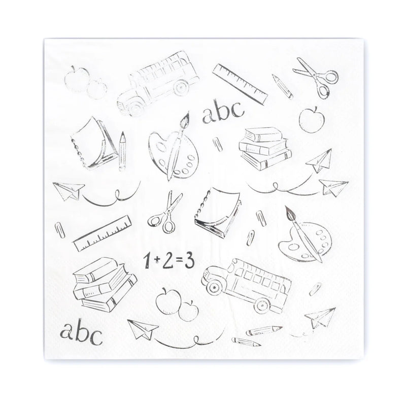 Flat lay of single white lunch napkin printed with silver school icons and ‘1 + 2 = 3’.