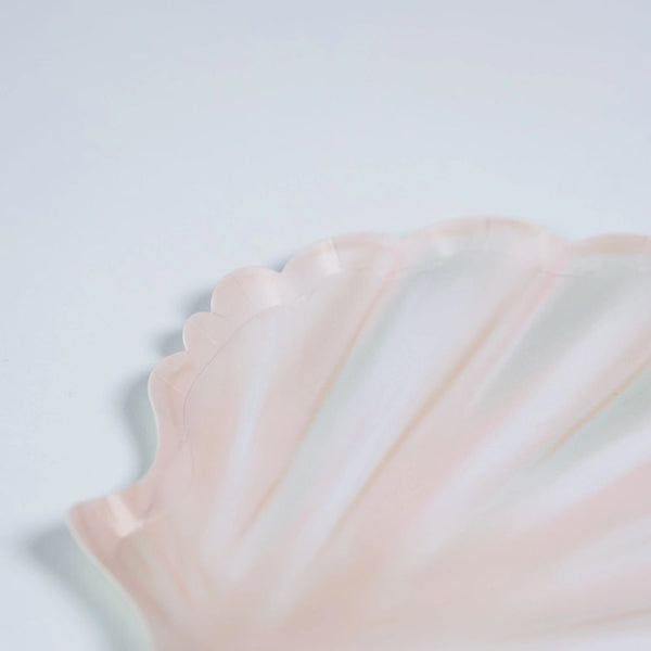 close up of seashell dessert plates with soft blush tones and scalloped edges.