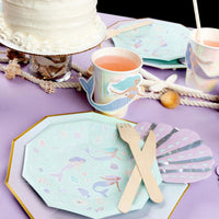 Seashell napkin with mermaid plates and party setup